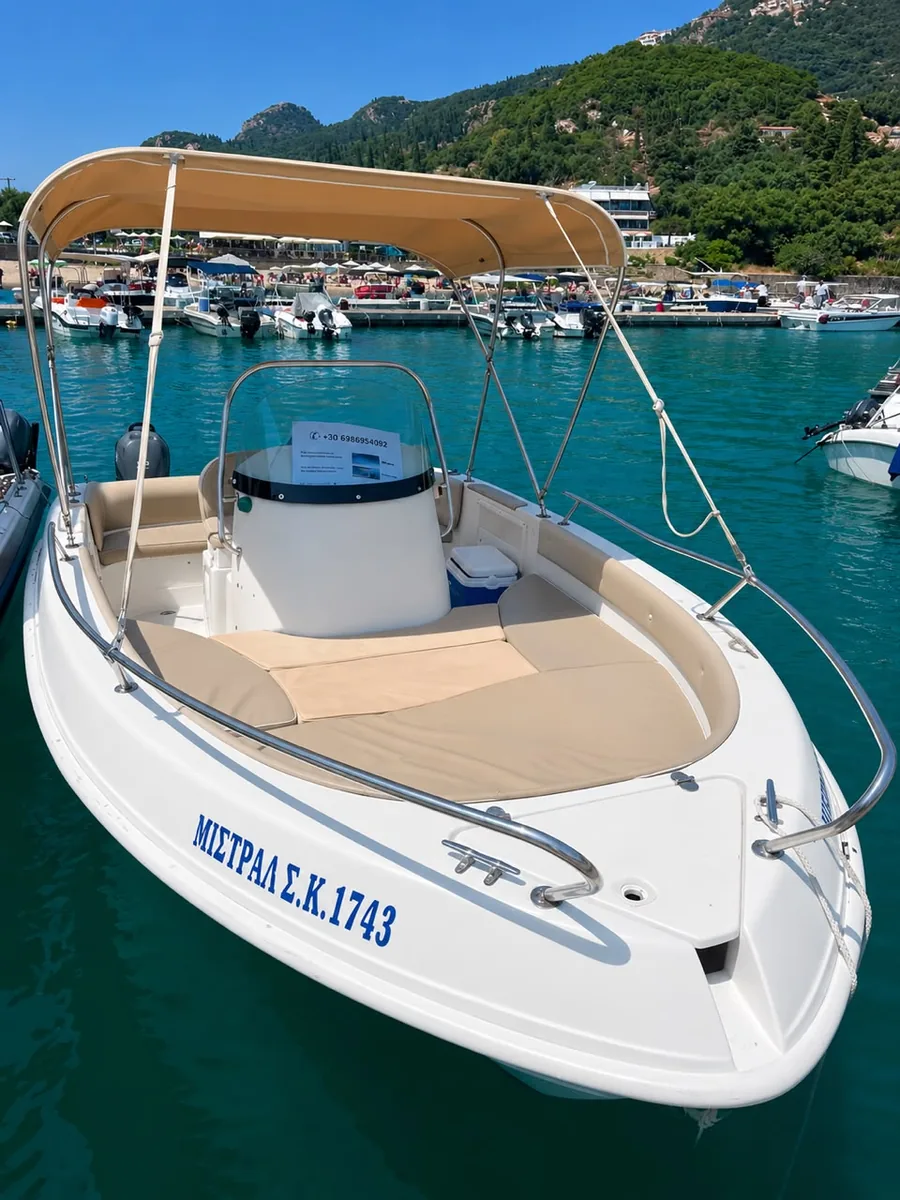 The Mistral from the quay, showing the cushioned seating and the hull registration.