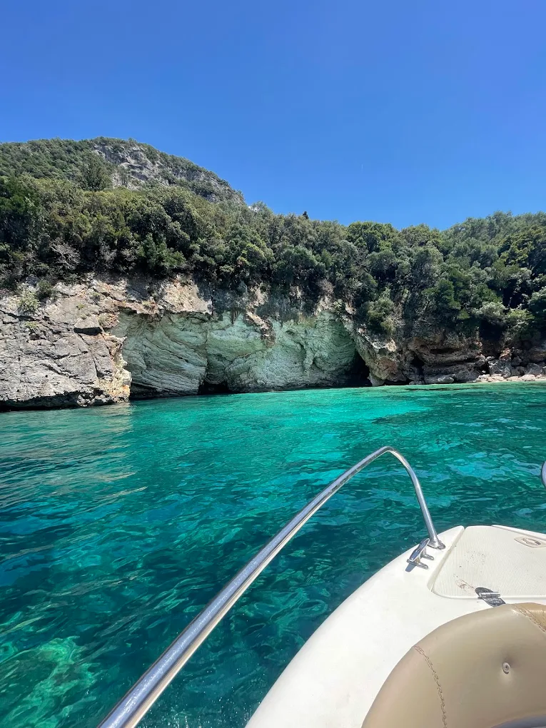 A low limestone overhang above turquoise water on the Paleokastritsa coast.