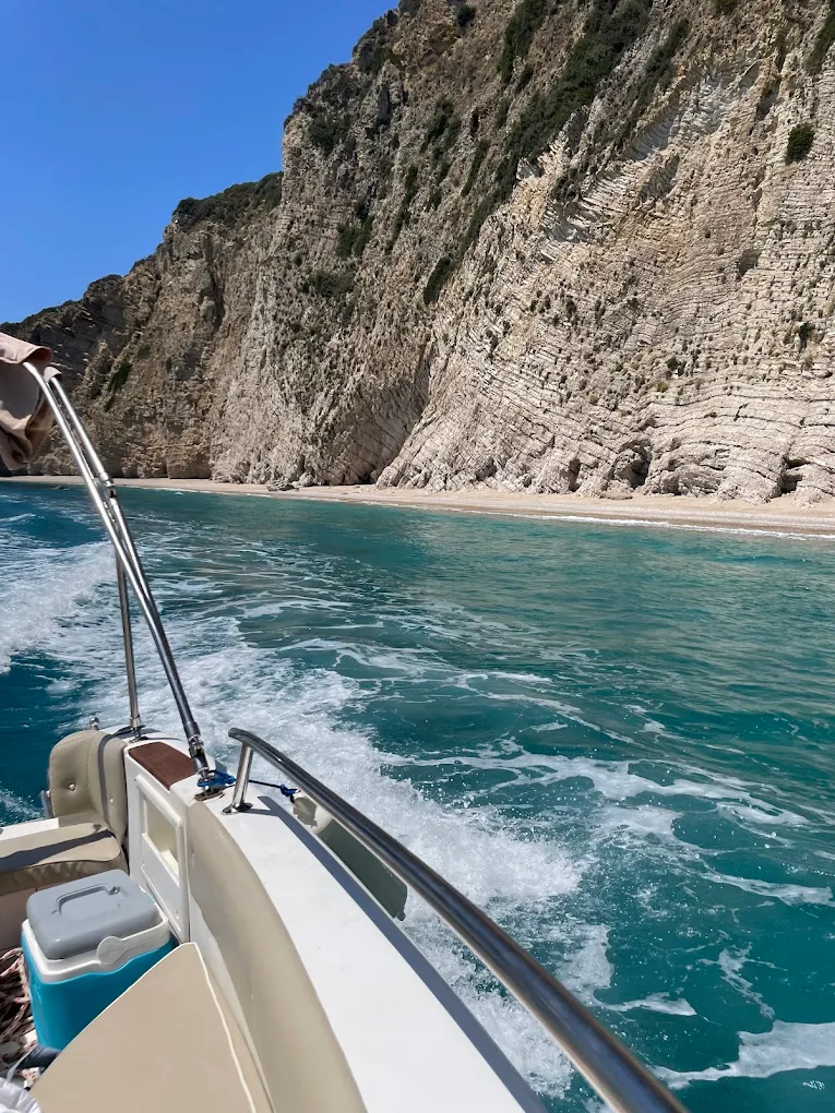 The beach below the cliffs at Iliodoros, seen from a boat under way.